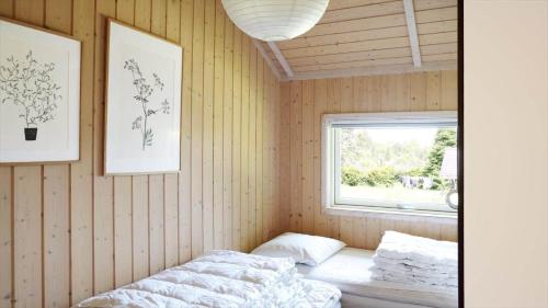 a bedroom with a bed and a window in it at 13376-Asnaes-Dommergardsvej-18 in Asnæs