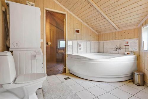 a bathroom with a large tub and a toilet at 13376-Asnaes-Dommergardsvej-18 in Asnæs