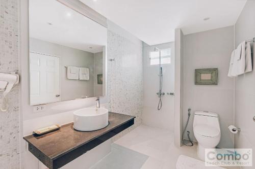 a white bathroom with a sink and a toilet at Combo Beach Hotel Samui in Chaweng