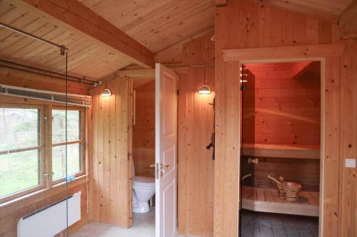 a bathroom with a toilet in a wooden house at 10084-1-Rorvig-Sondervangen-12 in Rørvig