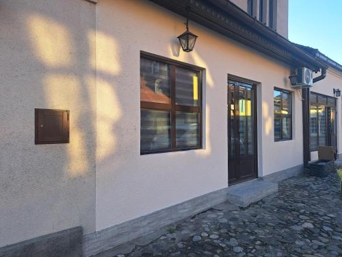 a white building with a door and a window at Stefanovic in Valjevo