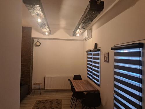 a dining room with a wooden table and chairs at Stefanovic in Valjevo