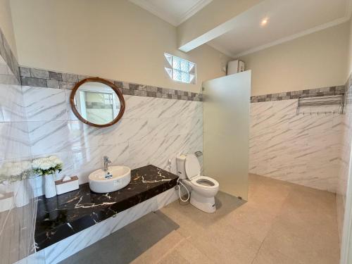 a bathroom with a sink and a toilet at Bunut Sari Guesthouse in Ungasan