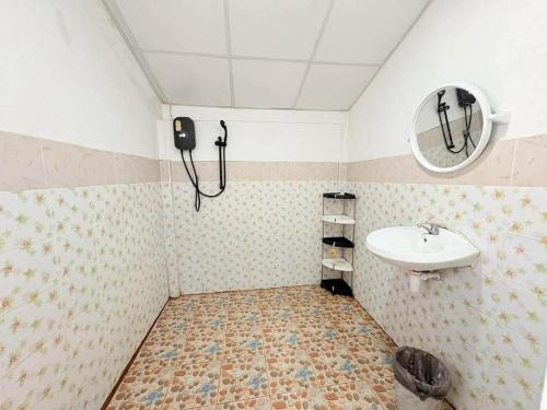 a bathroom with a sink and a mirror at Magic Garden Residence Bangkok in Bangkok