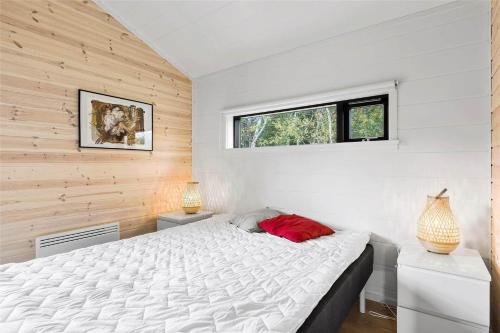 a bedroom with a white bed and two windows at 10036-Rorvig-Magevej-11 in Rørvig