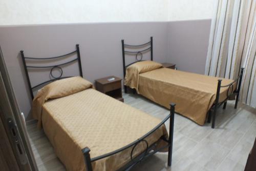 pokój z 2 łóżkami w pokoju w obiekcie Casa Archimede w Syrakuzach