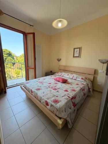 a bedroom with a bed and a large window at I Barsan in Groppo