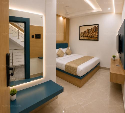 a hotel room with a bed and a mirror at New Skyrooms in Varanasi
