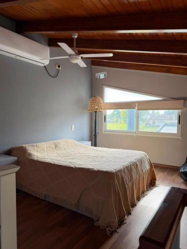 a bedroom with a bed and a ceiling fan at Alborada in Gualeguaychú