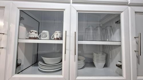 a cabinet with plates and cups and dishes in it at Vacation Villa - Katunayake in Kotugoda