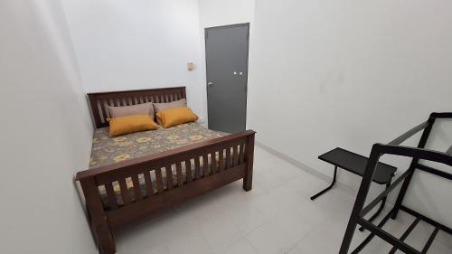 a bed with two pillows on it in a room at Vacation Villa - Katunayake in Kotugoda
