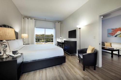 a hotel room with a bed and a desk and chair at Meliá Orlando Celebration in Orlando