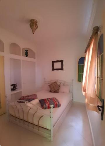 a white bedroom with a bed in a room at San Marcelo De Tangier in Tangier