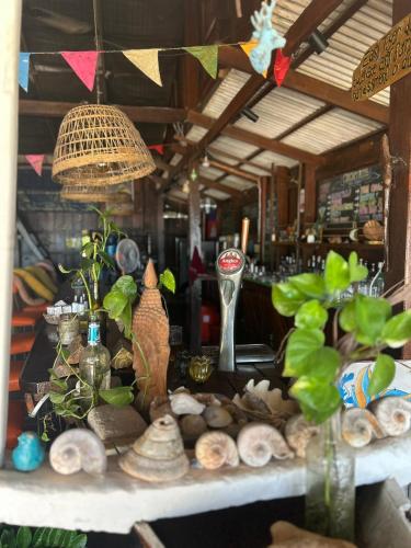 a table with vases and other items on it at Easy Tiger - M'Pai Bay Beach, Koh Rong Sanloem in Koh Rong Sanloem