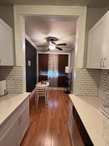 a kitchen with a table and a ceiling fan at Cute Downtown Stay near Toyota Center & Midtown in Houston