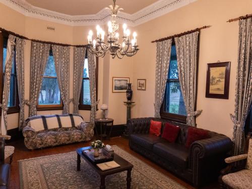 a living room with a couch and a bed at Lochinvar House in Lochinvar