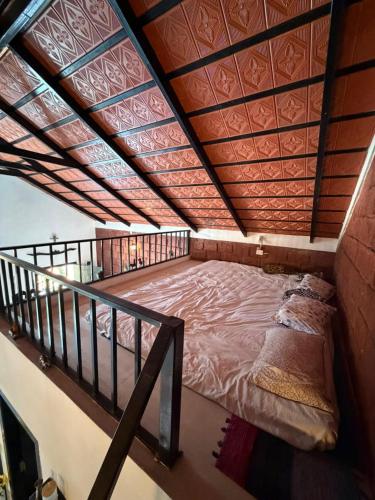 a large bed in a room with a balcony at Koppalu Heritage in Vastāra