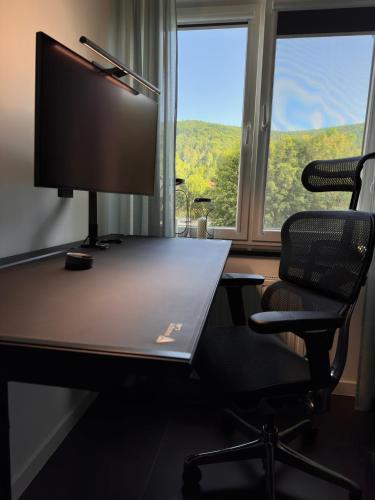 an office with a desk with a computer and a chair at Apartamenty Cisza - Ustrzyki Dolne noclegi - Bieszczady noclegi in Ustrzyki Dolne