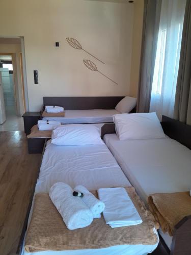a row of beds in a room with towels on them at Leni in Ierissos