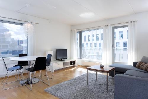 a living room with a couch and a table at BJØRVIKA APARTMENTS, Teaterplassen, Oslo city center in Oslo