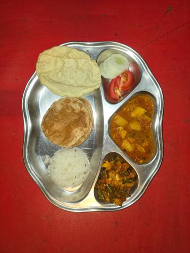 a tray of food with different types of food on it at WoodPacker Hostel Auroville Pondicherry in Auroville
