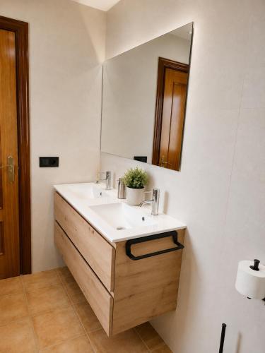 a bathroom with a sink and a mirror at CASA PUIG, Piscina Privada ,Aire Acondicionado Free in L'Escala