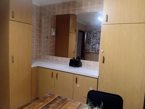 a small kitchen with a table and a mirror at Lindas Haven in Swakopmund