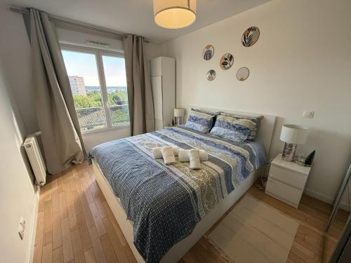 a bedroom with a bed with two towels on it at Cozy Suite La Défense in Nanterre
