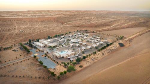 an aerial view of a building in the desert at Arabian Nights Resort & Spa in Shāhiq