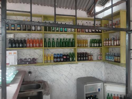 a bar with a bunch of bottles on the wall at Bububu creek house in Mombasa