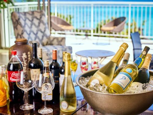 a table with bottles of champagne and wine glasses at Hotel Resonex Nago in Nago
