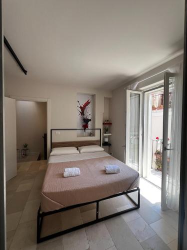 a bedroom with a large bed and a large window at Affittacamere gold 5 in Barletta