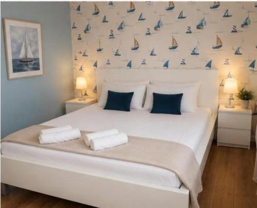 a bedroom with a large white bed with sails on the wall at Mare Nostrum Suite in Vir