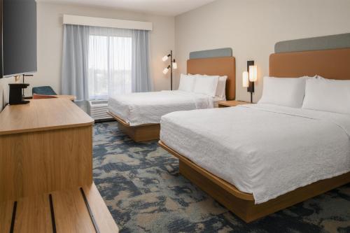 a hotel room with two beds and a television at Hampton Inn & Suites Prescott Valley in Prescott Valley