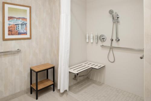 a shower stall with a bench in a bathroom at Hampton Inn & Suites Prescott Valley in Prescott Valley