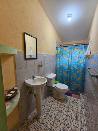 a bathroom with a sink and a toilet and a shower at Hostal San Antonio in León
