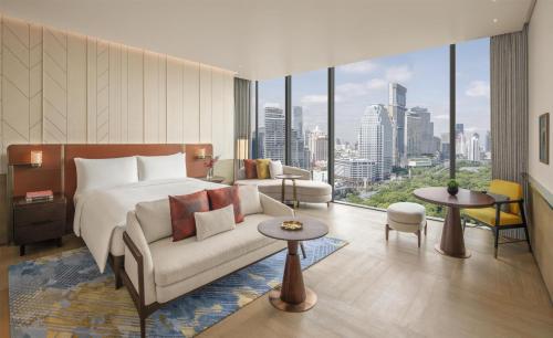 a hotel room with a bed and a couch at Andaz One Bangkok, by Hyatt in Bangkok