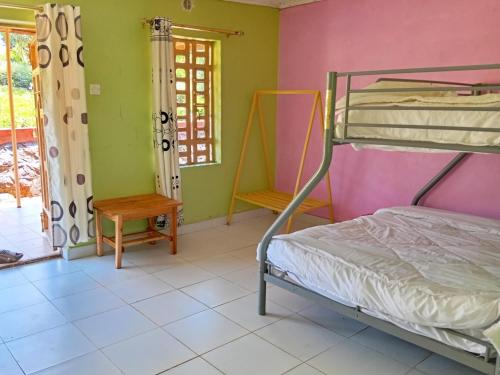 a bedroom with a bunk bed and a window at Lago Resort - Kakamega Forest in Kakamega