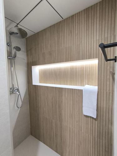 a bathroom with a shower with a towel on a wall at Las Casillas de Laujar in Laujar de Andarax