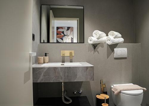 a bathroom with a sink and a toilet at Aeon Blue in Selianitika