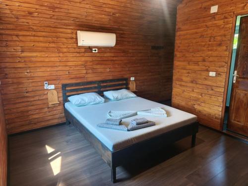 a bedroom with a bed in a wooden wall at "La Aurel" Mahmudia in Mahmudia