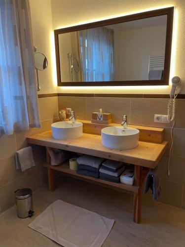 a bathroom with two sinks and a large mirror at Haus Priller in Sillian