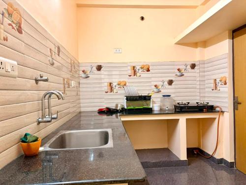 a kitchen with a sink and a counter at De Quite Villa in Pondicherry