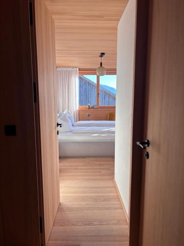 an open door leading to a bedroom with a tub at Panoramazimmer im Bregenzerwald in Schwarzenberg