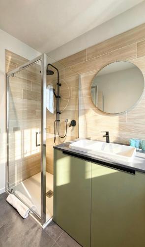 a bathroom with a shower and a sink and a mirror at Casa Nanà - Sottomarina in Chioggia