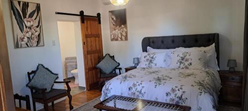 a bedroom with a bed and a table and chairs at Eagles Accommodation in Colesberg