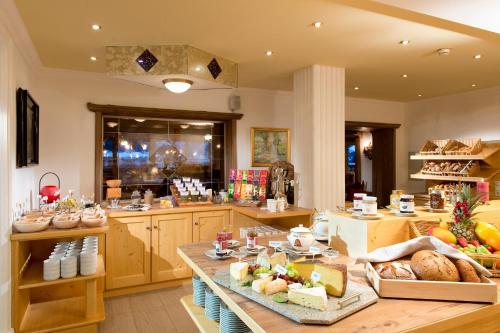 a kitchen with a table with food on it at Sporthotel Schönruh in Ehrwald