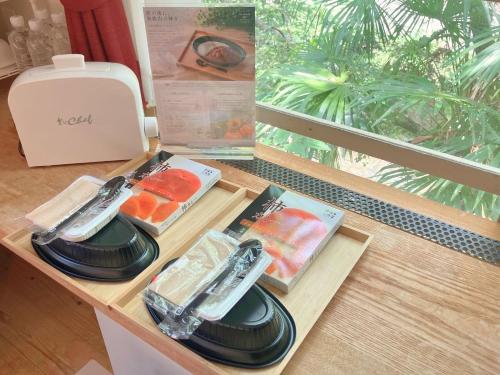 a table with three plates of food on it at The Railway Hotel Koyasan Pilgrimage Railway - Station Inn - Self Check-in Only in Kudoyama