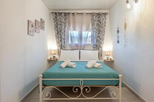 a bedroom with a bed with two towels on it at Lydia Guest House in Palekastron