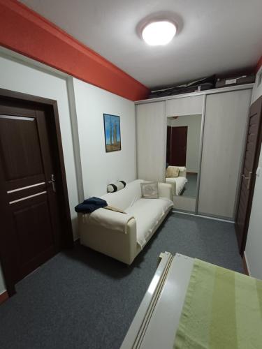 a living room with a couch and a mirror at Izba v centre in Bardejov